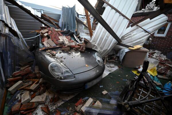 The remains of a collapsed roof lie on a Porsche after hurricane Zeynep in Eversmeer, Germany, on Feb. 19, 2022. Lars-Josef Klemmer/dpa via AP)