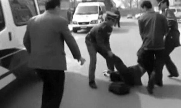 An "enemy of the state" being hauled off by the Chinese Communist Party (CCP) authorities, in “Canaries in a Cold War.” (Magnason Films)
