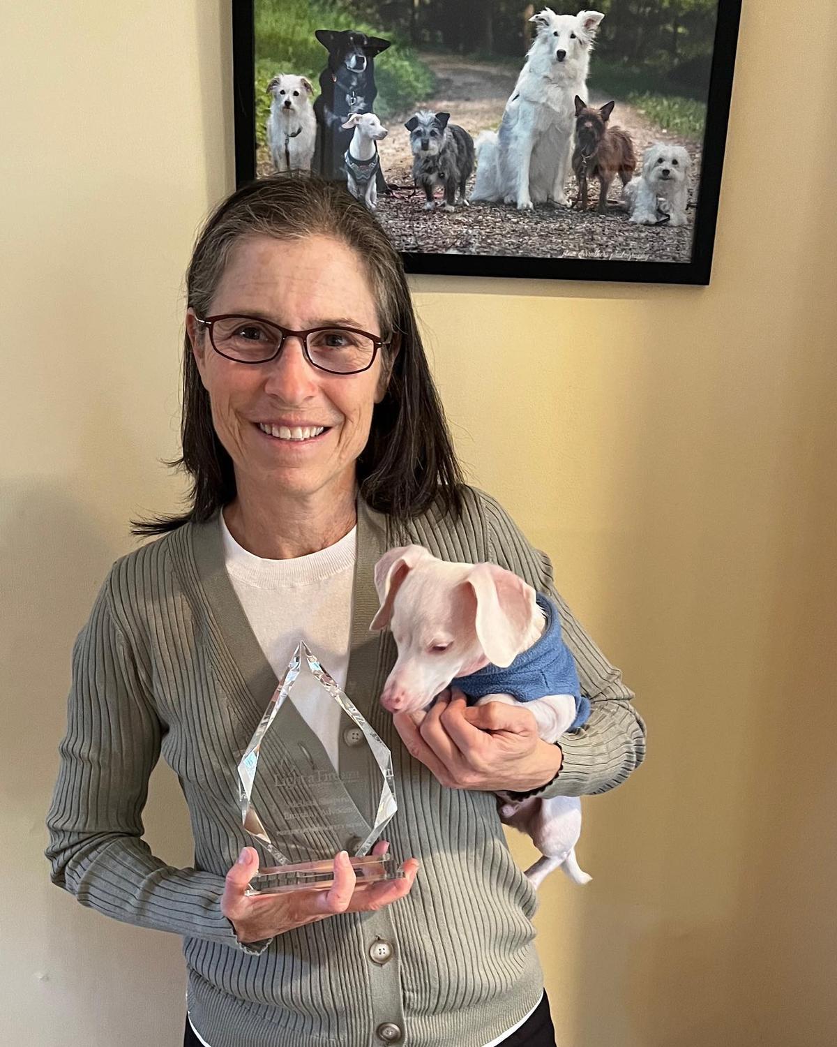 Shapiro and Piglet with Moffly Media’s 2021 Light a Fire Empathy Advocate Award. (Courtesy of <a href="https://www.instagram.com/pinkpigletpuppy/">Piglet, deaf blind pink puppy</a>)