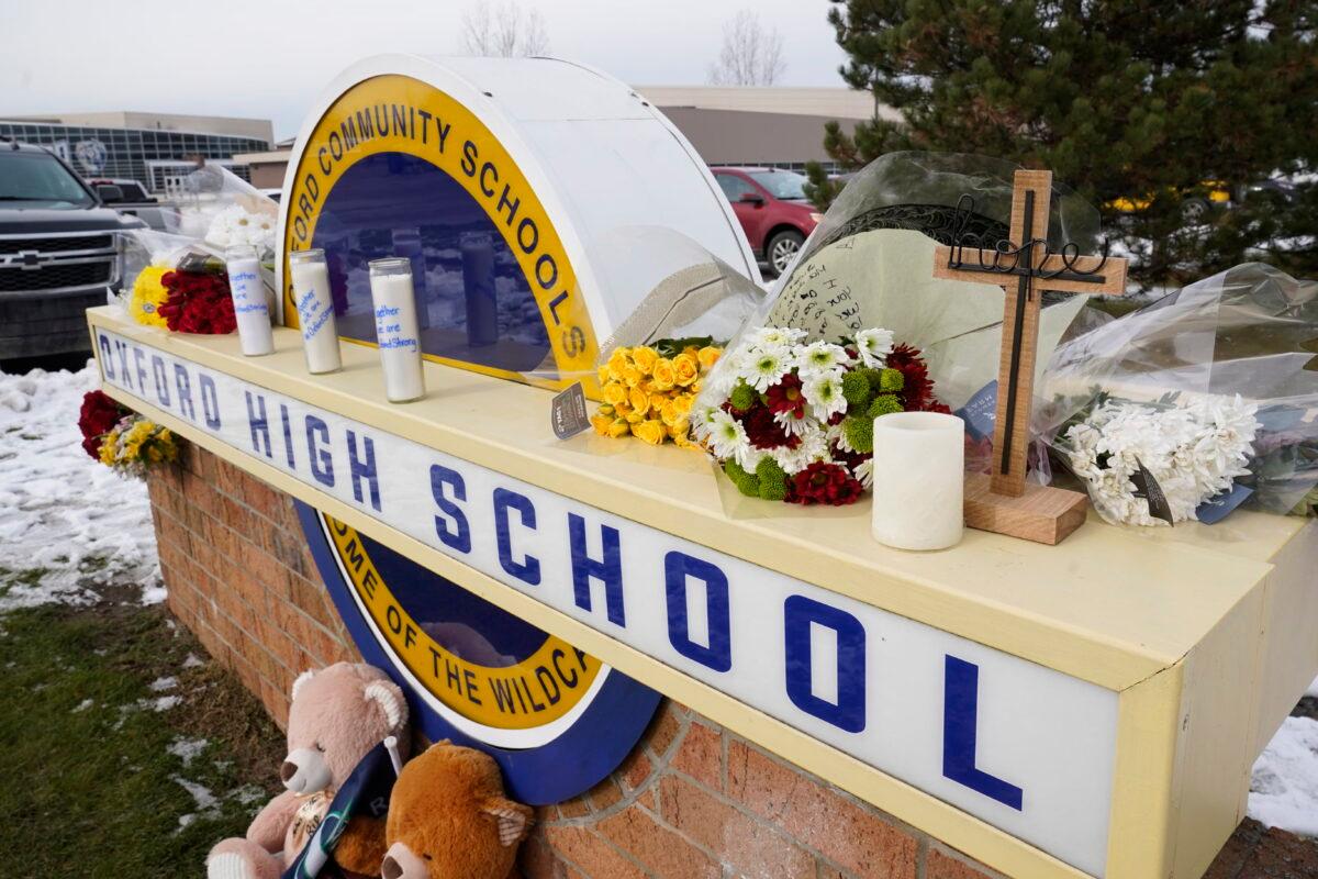 Memorial items on the sign of Oxford High School in Oxford, Mich., on Dec. 1, 2021. (Paul Sancya/AP Photo)