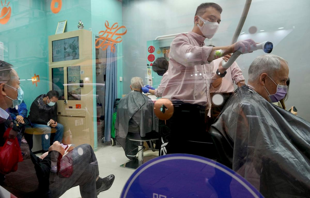 People get haircuts at a salon before temporarily closing later in the week in Hong Kong, on Feb. 9, 2022. (Vincent Yu/AP Photo)