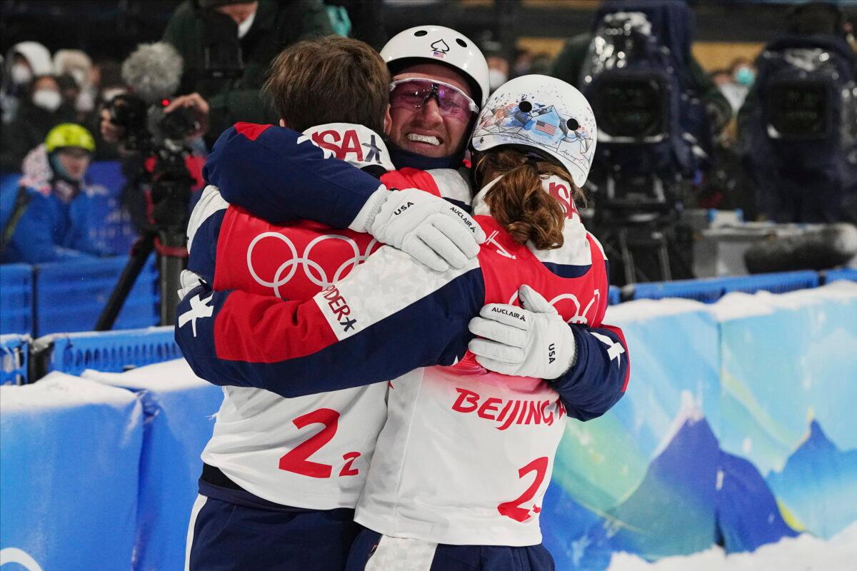 Justin Schoenefeld (C) celebrates with Christopher Lillis (L) and Ashley Caldwell (R) of the United States during the mixed team aerials finals at the 2022 Winter Olympics in Zhangjiakou, China, on Feb. 10, 2022. (Gregory Bull/AP Photo)
