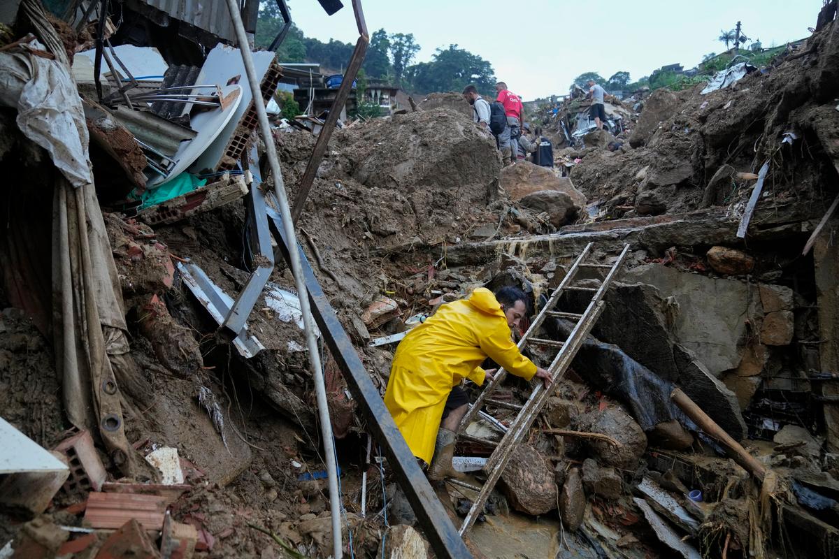 Rescue workers and residents search for victims in an area affected by landslides in Petropolis, Brazil, on Feb. 16, 2022. (Silvia Izquierdo/AP Photo)