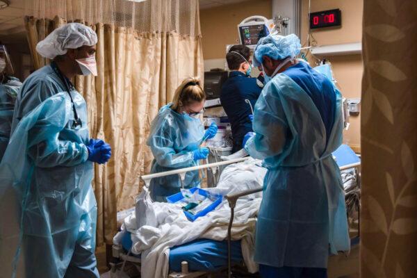 Health care workers tend to a patient in a January 2021 file photo. (Ariana Drehsler/AFP/Getty Images)