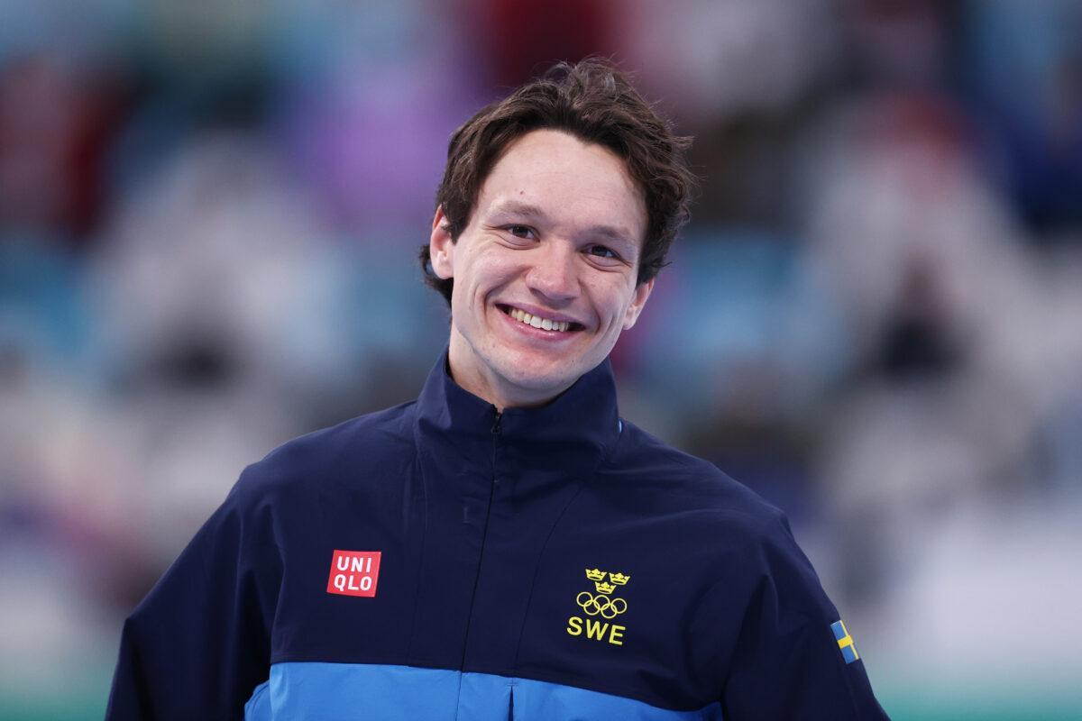 Gold medalist Nils van der Poel of Team Sweden celebrates during the Men's 10,000-meter flower ceremony after setting a new World Record time of 12:30.74 on day seven of the Beijing 2022 Winter Olympic Games at National Speed Skating Oval in Beijing on Feb. 11, 2022. (Dean Mouhtaropoulos/Getty Images)