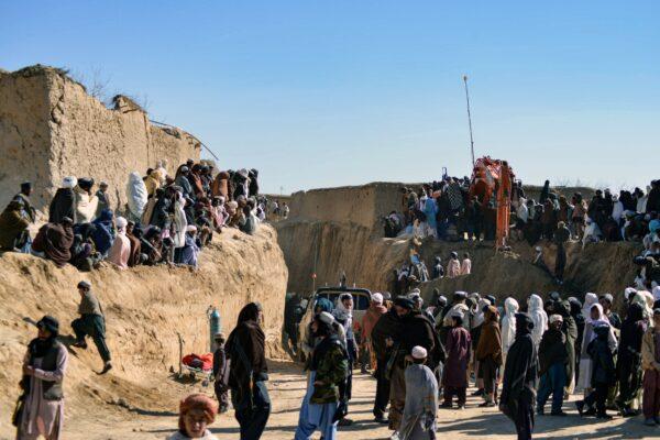 Afghan people gather as rescuers try to reach and rescue a boy trapped for two days down a well in a remote southern Afghan village of Shokak, in Zabul province about 120 kilometers from Afghanistan's second largest city of Kandahar on Feb. 17, 2022. (JAVED TANVEER/AFP via Getty Images)