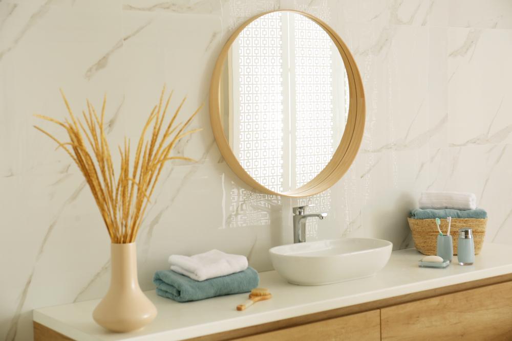 Round mirrors help bring softness and visual contrast in a functional space. (New Africa/Shutterstock)
