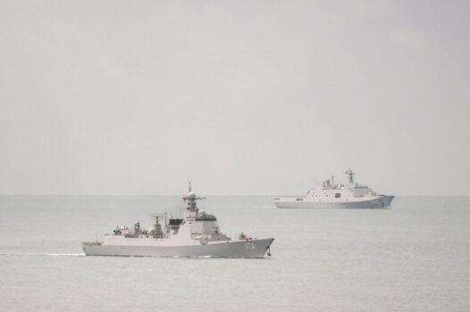 A People's Liberation Army Navy (PLA-N) Luyang-class guided-missile destroyer (left) and a PLA-N Yuzhao-class amphibious transport dock vessel leave the Torres Strait and enter the Coral Sea on Feb. 18, 2022 (Supplied/Australian Defence Department).