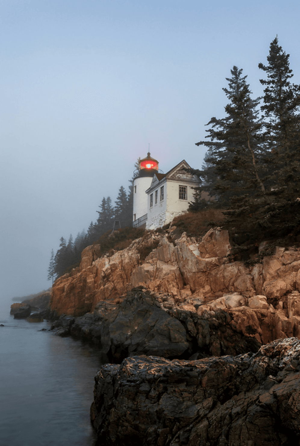 The morning fog rises over the Bass Harbor Head Lighthouse. (Peter Wood for American Essence)