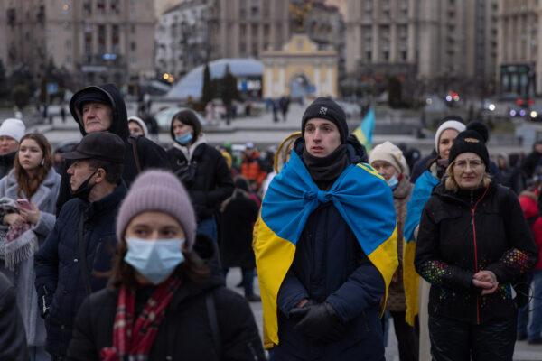 People sing the Ukrainian national anthem during a rally in support of Ukraine held during Maidan Revolution commemoration ceremonies in Kyiv on Feb. 20, 2022. (Chris McGrath/Getty Images)