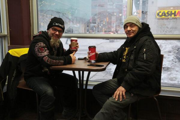 Quebec trucker Stephane Elia (L) and Ottawa resident Gaston Lanthier in a central Ottawa cafe on Feb. 16, 2022. (Richard Moore/The Epoch Times)
