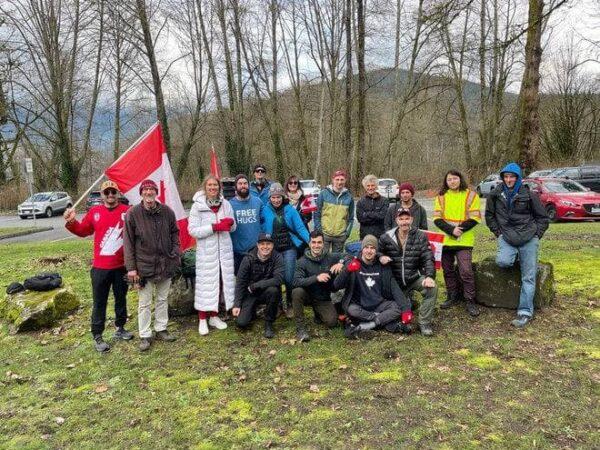James Topp (Front Right) and supporters take a group photo in Maple Ridge, B.C., the first stop in Topp's 4,300-kilometre journey on foot across Canada to oppose COVID-19 mandates, on Feb. 20, 2022. (Courtesy James Topp)