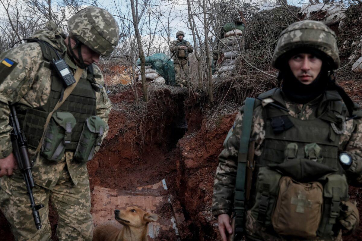 Ukrainian service members on the front line near the city of Novoluhanske in the Donetsk region, Ukraine on Feb. 20, 2022. (Gleb Garanich/Reuters)
