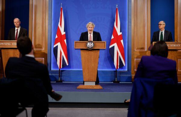 Chief Medical Officer Sir Chris Whitty, Prime Minister Boris Johnson, and Chief Scientific Adviser Sir Patrick Vallance address the nation during a press conference on plan for "Living With COVID" at Downing Street Briefing Room, in London, on Feb. 21, 2022. (Tolga Akmen - WPA Pool/Getty Images)