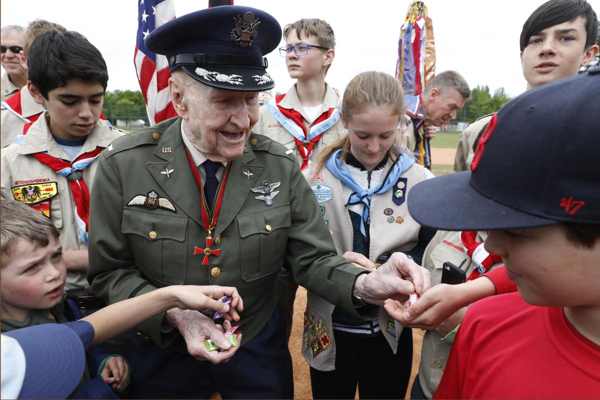 Former Berlin airlift pilot Gail Halvorsen from the United States distributes candies to the members of the junior local Baseball team "Berlin Braves" and members of the Boy Scouts of America during a ceremony at the Tempelhofer Feld, a former airfield in Berlin, on May 11, 2019. (Michele Tantussi/AFP via Getty Images)
