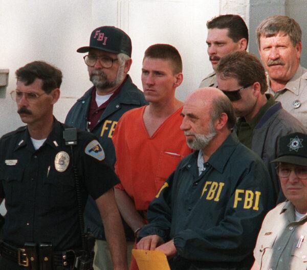 Timothy McVeigh (C) being led from Noble County Courthouse in Perry, Okla., on April 21, 1995. (BOB DAEMMERICH/AFP via Getty Images)
