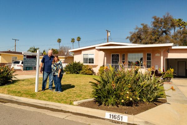 The Peterson family stands on their Garden Grove property currently in escrow as they transition to their new home in Laughlin, Nevada on Feb. 07, 2021. (John Fredricks/The Epoch Times)