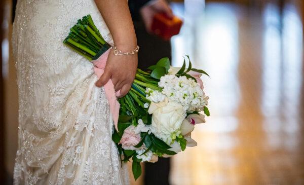 A bride holds a wedding bouquet at Old Orange County Courthouse in Santa Ana, Calif., on Feb. 22, 2022.