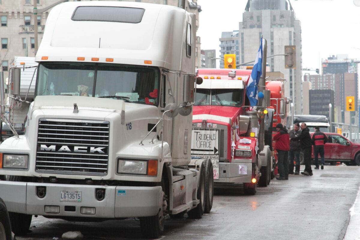 Trucks are seen parked in central Ottawa on Feb. 14, 2022, in protest of federal COVID-19 mandates and restrictions. (Richard Moore/The Epoch Times)