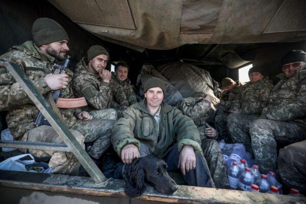 Ukrainian servicemen sit in the back of military truck in the Donetsk region town of Avdiivka, on the eastern Ukraine front line with Russia-backed separatists on Feb. 21, 2022. (Aleksey Filippov/AFP via Getty Images)