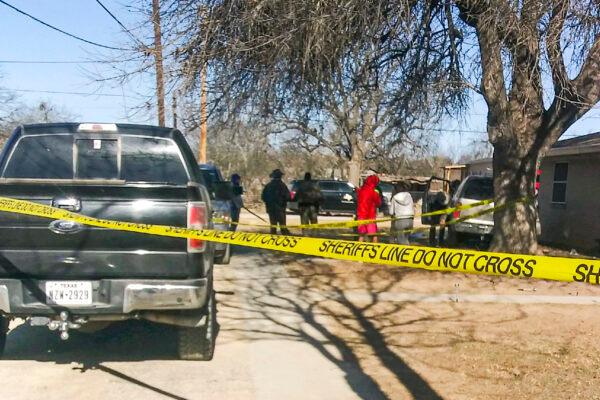 Law enforcement and emergency personnel aid the driver and passenger of a truck that rolled and hit a house during a high-speed chase in Brackettville, Texas, on Feb. 18, 2022. (Courtesy of Katherine Vasquez)