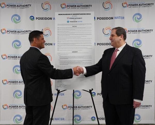 Poseidon Water Vice President Scott Maloni (L) and Brian Probolsky, CEO of Orange County Power Authority, sign the official Memorandum of Understanding to work together toward making the Huntington Beach Seawater Desalination Plant the first of its kind in the Western Hemisphere to be powered entirely by renewable energy in Irvine, Calif., on Feb. 22, 2022. (Courtesy of Orange County Power Authority)