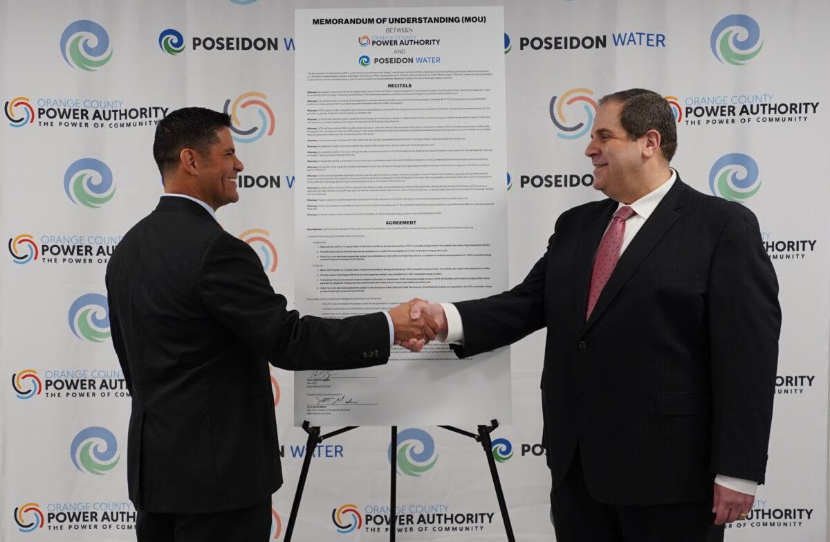 Brian Probolsky (R), CEO of Orange County Power Authority, shakes hands with Poseidon Water Vice President Scott Maloni in an agreement to work together toward desalination efforts in Irvine, Calif., on Feb. 22, 2022. (Courtesy of Orange County Power Authority)