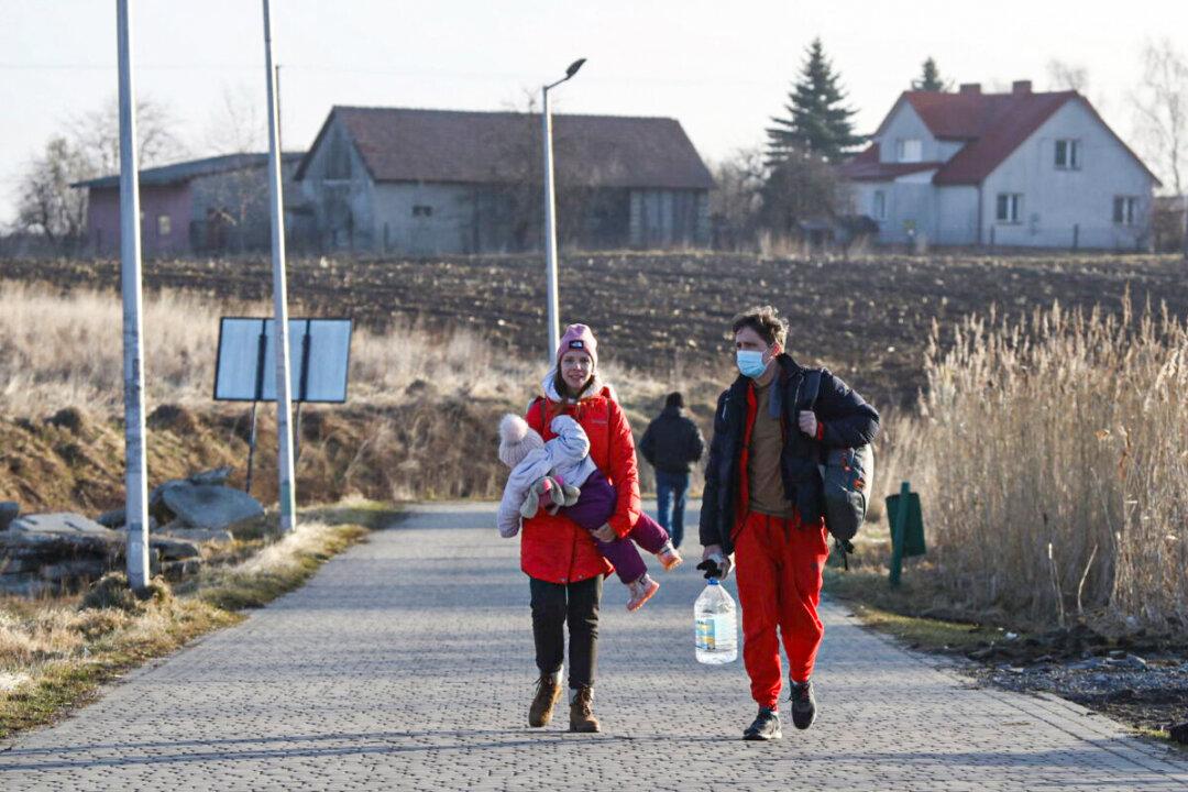 Leaving Behind Possessions and Pets, Ukrainians Flee to Poland
