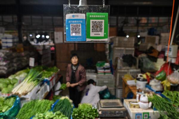 Alipay (L) and WeChat (R) QR payment codes displayed at a market in Shanghai on Oct. 27, 2020. (Hector Retamal/AFP via Getty Images)