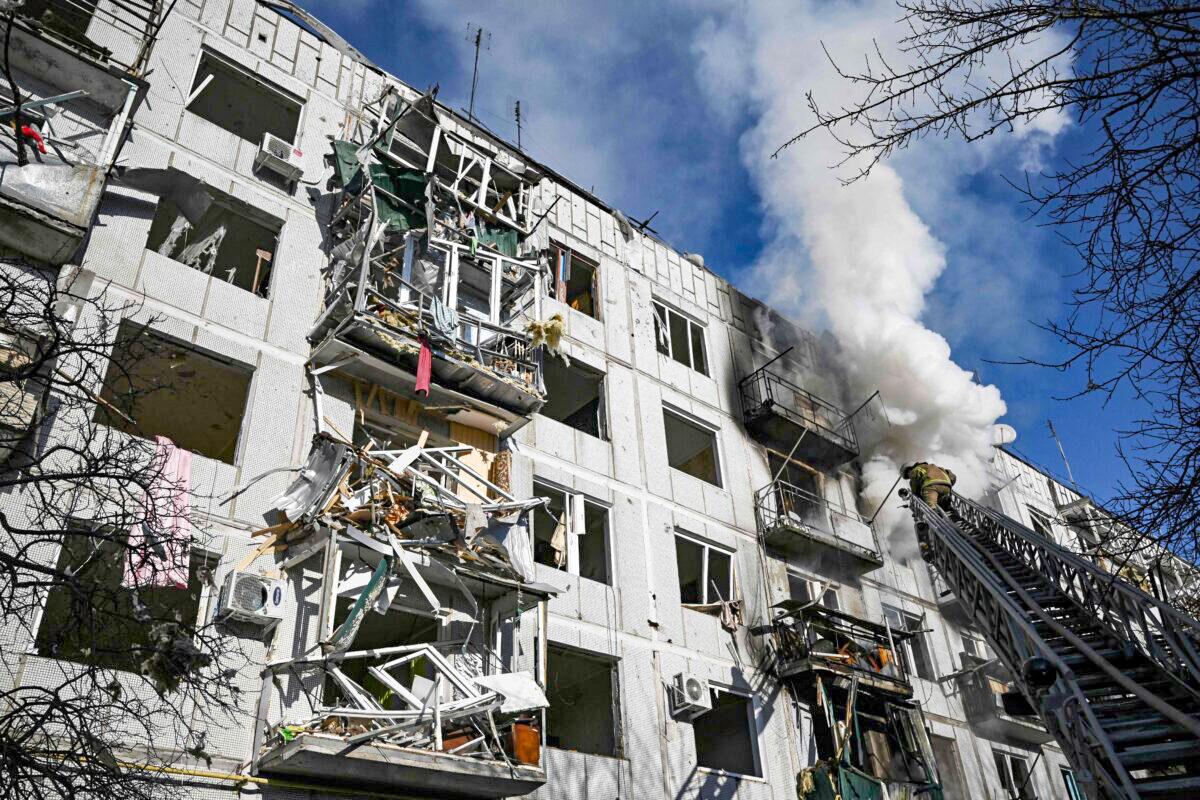 Firefighters work on a fire on a building after bombings on the eastern Ukraine town of Chuguiv on Feb. 24, 2022. (Aris Messinis/AFP via Getty Images)