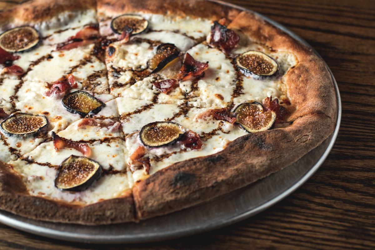 Locally harvested and ground mesquite flour lends a nutty depth to Figgy Stardust Pizza at Zio Peppe. The pie is topped with honeyed cheese embellished with dried figs and pomegranate concentrate. (Courtesy of Zio Peppe)