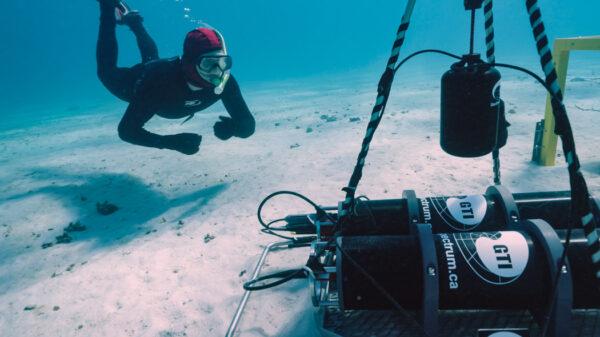 Miles Parsons collects underwater sounds from a coral reef. (Australian Institute of Marine Science)