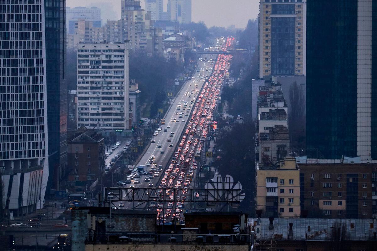 Inhabitants of Kyiv leave the city following pre-offensive missile strikes of the Russian armed forces and Belarus from the territory of Belarus on Feb. 24, 2022 in Kyiv, Ukraine. (Chris McGrath/Getty Images)