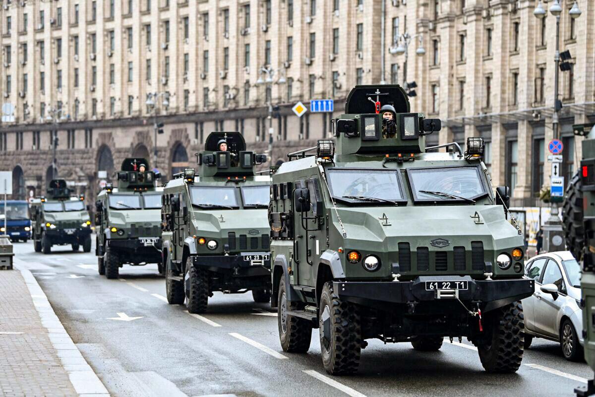 Ukrainian military vehicles move past Independence square in central Kyiv on Feb. 24, 2022. (Daniel Leal/AFP via Getty Images)