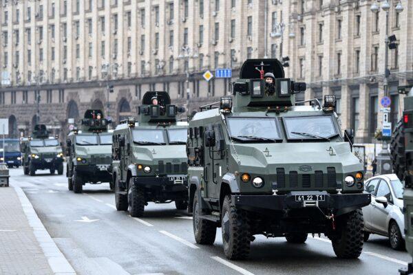 Ukrainian military vehicles move past Independence square in central Kyiv on Feb. 24, 2022. Air raid sirens rang out in downtown Kyiv on Feb. 24 as cities across Ukraine were hit by Russian missile strikes and artillery. (Daniel Leal/AFP via Getty Images)