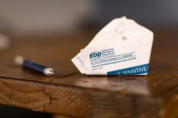 A discarded envelope containing EDD information sits in Irvine, Calif., on April 21, 2021. (John Fredricks/The Epoch Times)