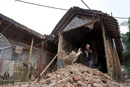 A resident cleans the debris of his damaged house a day after a 6.2-magnitude earthquake hit the area at Kertamukti village in Pandeglang, Indonesia, on Jan. 15, 2022. ((Dziki Oktomauliyadi/AFP via Getty Images)