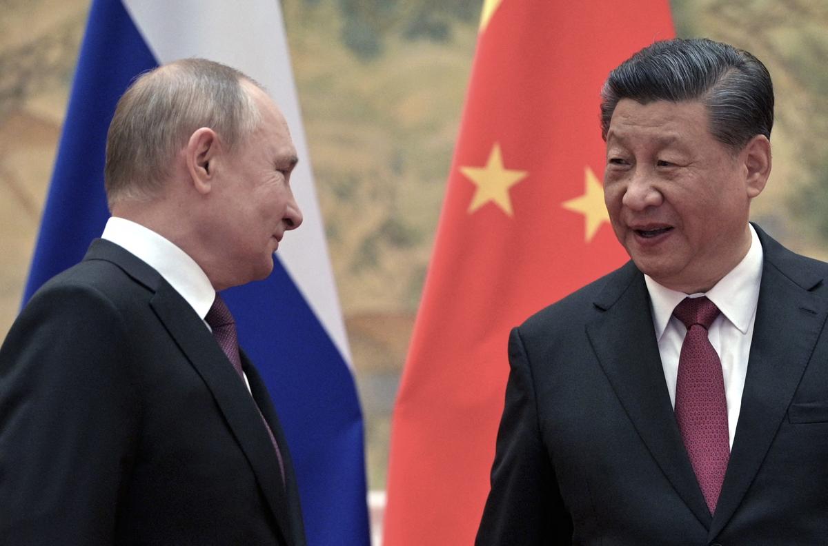Russian President Vladimir Putin (L) and Chinese leader Xi Jinping arrive to pose for a photograph during their meeting in Beijing, on Feb. 4, 2022. (Alexei Druzhinin/Sputnik/AFP via Getty Images)