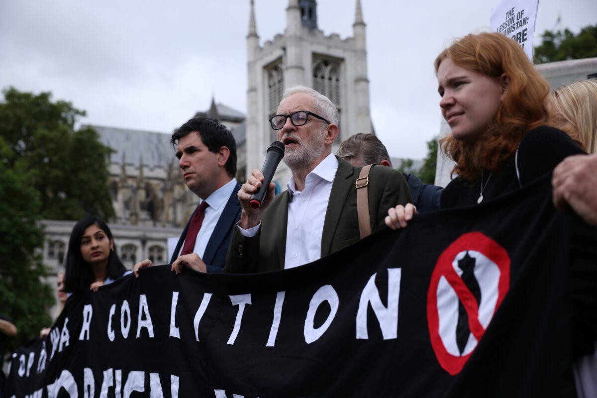 (L-R) Labour MP Richard Burgon and former leader of the Labour Party Jeremy Corbyn attend a protest rally organised by the Stop The War Coalition calling on the UK government to recognise the war in Afghanistan as a “catastrophe,” at Parliament Square, in London, on Aug. 18, 2021. (Dan Kitwood /Getty Images)