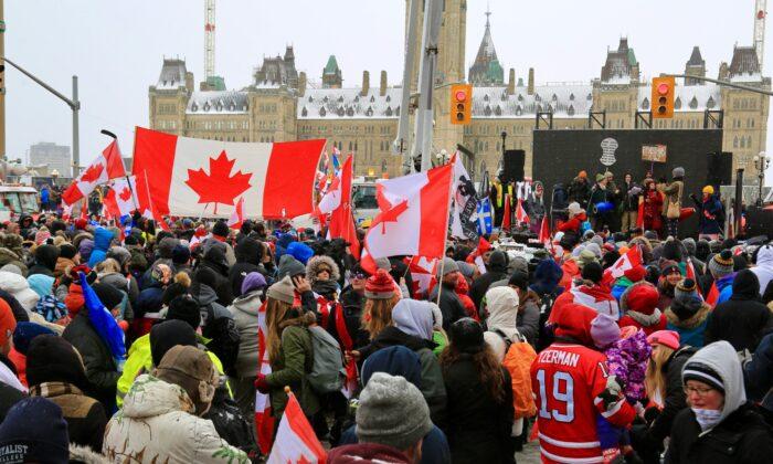 Crowds of protesters demonstrate against COVID-19 mandates and restrictions in downtown Ottawa on Feb. 12, 2022. (Jonathan Ren/The Epoch Times)