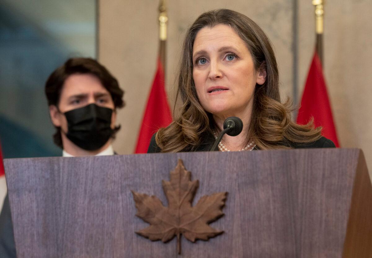 Canadian Prime Minister Justin Trudeau looks on as Deputy Prime Minister and Finance Minister Chrystia Freeland speaks during a news conference announcing that the Emergencies Act will be invoked to deal with protests, in Ottawa on Feb. 14, 2022. (The Canadian Press/Adrian Wyld)