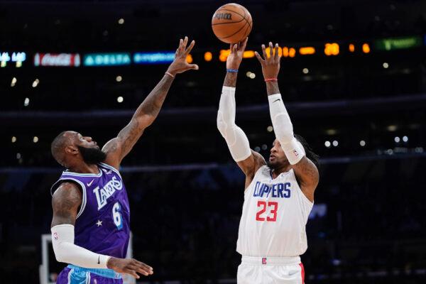 Los Angeles Clippers forward Robert Covington (R) shoots as Los Angeles Lakers forward LeBron James defends during the first half of an NBA basketball game in Los Angeles, on Feb. 25, 2022. (Mark J. Terrill/AP Photo)