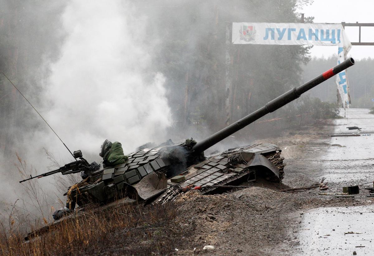 Smoke rises from a Russian tank destroyed by the Ukrainian forces on the side of a road in Lugansk region on Feb. 26, 2022. (Anatolii Stepanov/AFP via Getty Images)