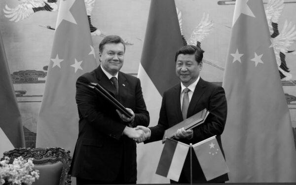 Former Ukrainian President Viktor Yanukovych shakes hands with Chinese leader Xi Jinping during a signing ceremony at the Great Hall of the People in Beijing, China, on Dec. 5, 2013. (Wang Zhao/AFP via Getty Images)
