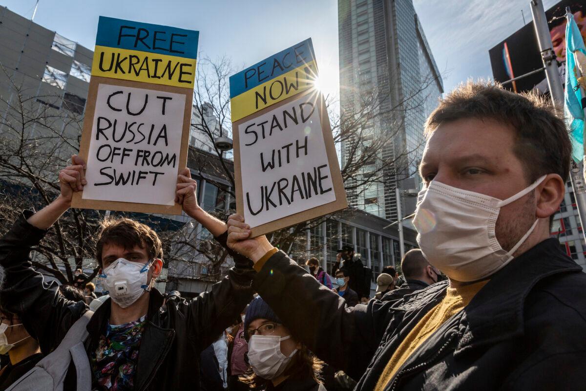 Protesters hold placards during a protest against Russia's attack on Ukraine, in Tokyo, Japan, on Feb. 26, 2022. (Yuichi Yamazaki/Getty Images)