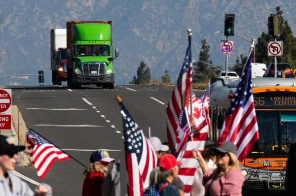 People gather in El Monte, Calif., to show support for truckers partaking in a convoy from Los Angeles to Washington, D.C in protest of mask and vaccine mandates on Feb. 25, 2022. (John Fredricks/The Epoch Times)