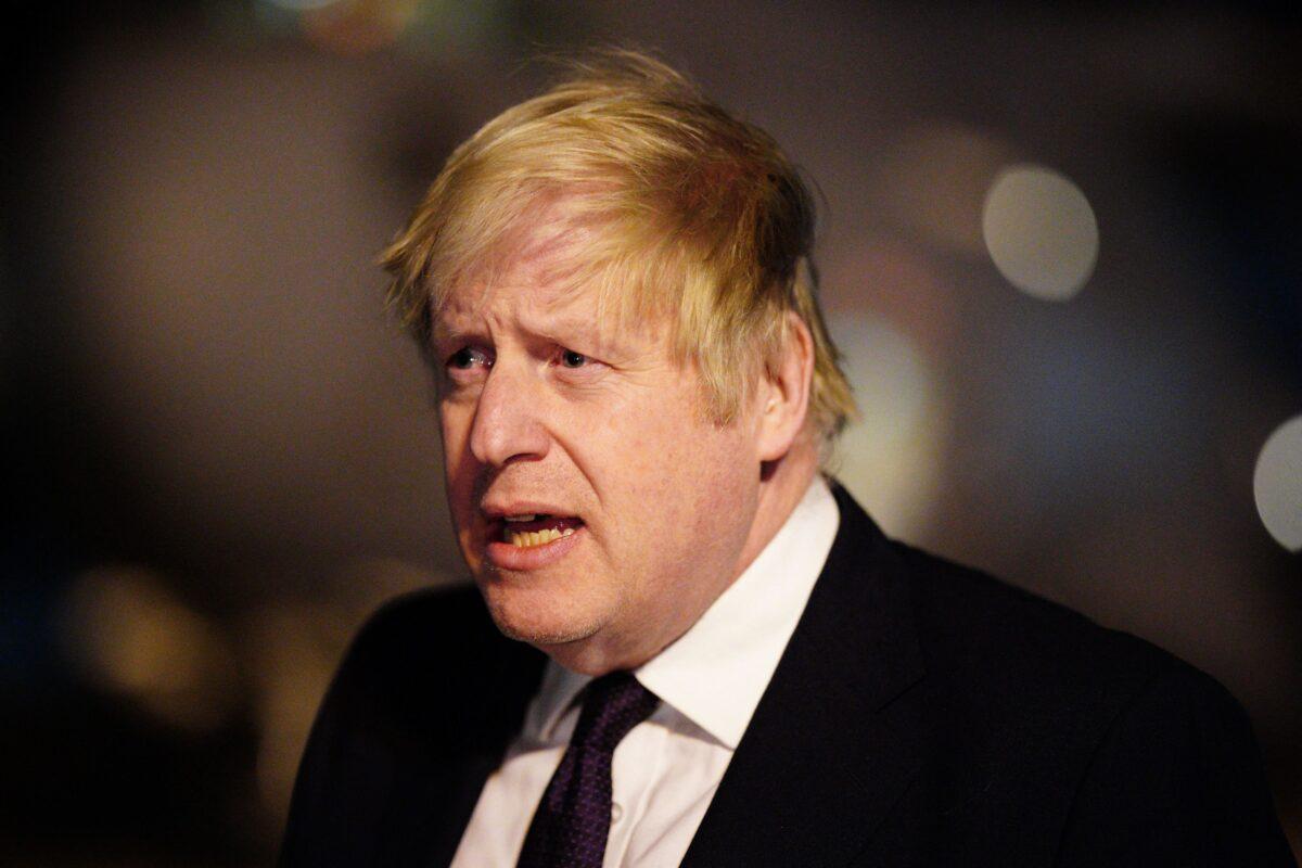 UK Prime Minister Boris Johnson meets with military personnel at RAF Brize Norton, northwest of London, on Feb. 26, 2022. (Ben Birchall/POOL/AFP via Getty Images)
