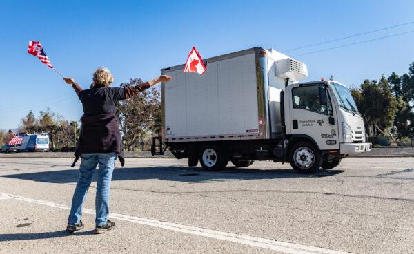 People gather in El Monte, Calif., to show support for truckers partaking in a convoy from Los Angeles to Washington, D.C., in protest of coronavirus mandates on Feb. 25, 2022. (John Fredricks/The Epoch Times)