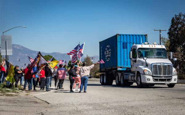 People gather in El Monte, Calif., to show support for truckers partaking in a convoy from Los Angeles to Washington, D.C., in protest of coronavirus mandates on Feb. 25, 2022. (John Fredricks/The Epoch Times)