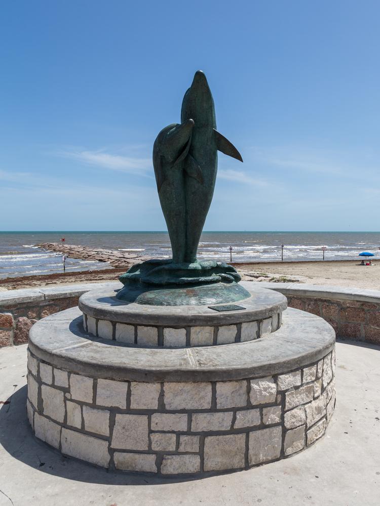Bronze sculpture with dolphins on the waterfront of the Gulf of Mexico in Galveston, Texas. (Oleg Anisimov/ Shutterstock)
